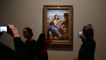 People take pictures of Leonardo da Vinci's "The Virgin and Child With Saint Anne" at the opening of the Louvre's exhibition in Paris on Oct. 22.