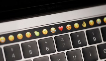 Using emoji at work can create miscommunication between generations. Above, emoticons are displayed on a MacBook.