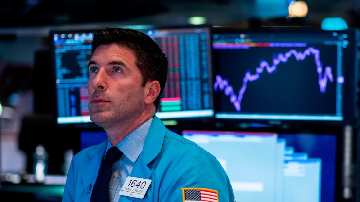 Traders work after the closing bell at the New York Stock Exchange on Aug. 12, when stocks finished a bruising session sharply lower as worries about slowing growth and the protracted U.S.-China trade war hit banking shares and the broader market.