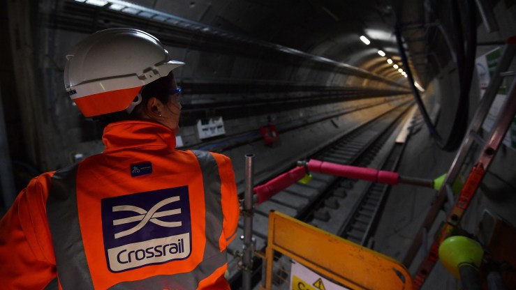 A worker looks along a train tunnel at the Canary Wharf Crossrail station in London in 2017.