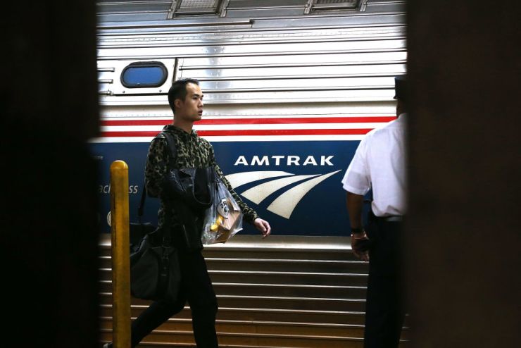 Passengers board an Amtrak train at New York City's Pennsylvania Station.