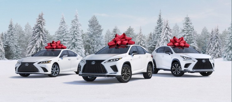 White Lexus cars with red bows against a snowy background, part of the "December to Remember" ad campaign thathas been running since 1999.