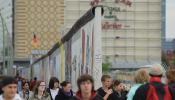 People walk past a section of the former Berlin Wall called the East Side Gallery in 2010, marking the 20th anniversary of reunification in Berlin.