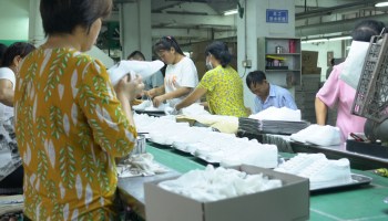 Workers at a shoe factory in southern China. Most of them come from the poor countryside to give their families a better life.