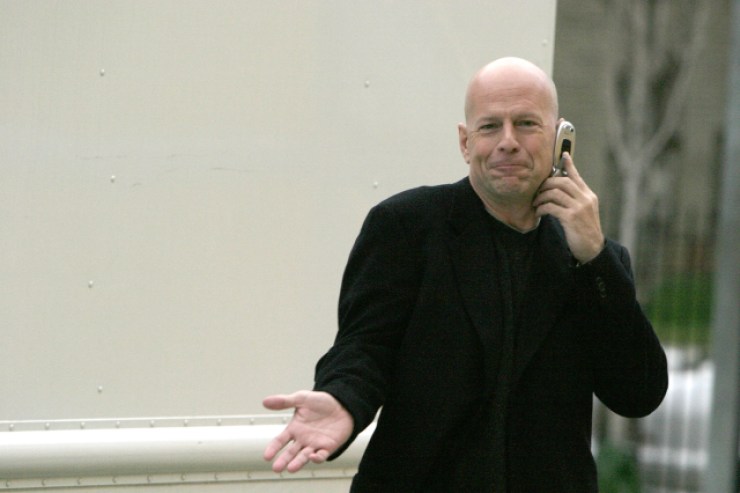 A photo of actor Bruce Willis on the phone in the 2000s.
