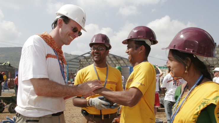 Jonathan Reckford, Habitat for Humanity CEO, chats with homeowners at a build site in India in 2006.