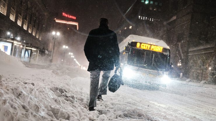 A man walks through a winter storm in Boston, MA in 2018.