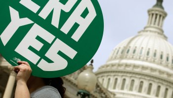 A woman hold up a sign as members of Congress and representatives of women's groups hold a rally to mark the 40th anniversary of congressional passage of the Equal Rights Amendment (ERA) outside the U.S. Capitol March 22, 2012 in Washington, DC.