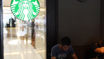 People sit in a Starbucks coffee shop in Beijing on July 28, 2017.