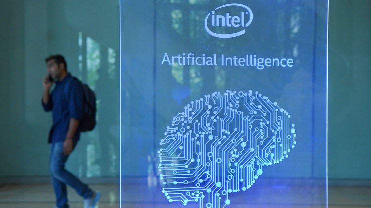 A visitor at Intel's Artificial Intelligence Day walks past a signboard during the event in the Indian city of Bangalore on April 4, 2017.
