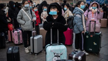 Chinese children wear protective masks as they wait to board trains at Beijing Railway station before the annual Spring Festival on January 21, 2020 in Beijing, China.