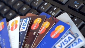 Credit cards are pictured on a computer keyboard