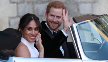 Prince Harry and Meghan Markle, Duchess of Sussex, wave as they leave Windsor Castle after their wedding to attend an evening reception at Frogmore House.