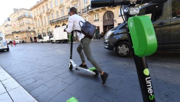 A man rides a Lime electric scooter on September 27, 2018 in the southwestern French city of Bordeaux
