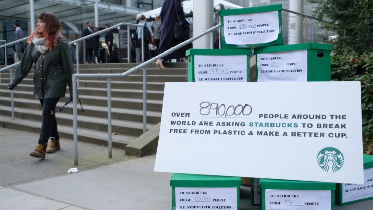 A sign encouraging Starbucks to use a more recyclable cup outside the company's annual shareholders meeting at McCaw Hall in 2018 in Seattle, Washington.