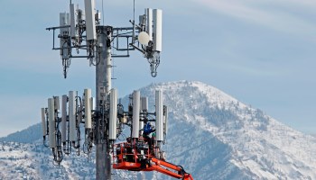 A crew for Verizon works on a cell tower to update it to handle the new 5G network in Orem, Utah on December 10, 2019.