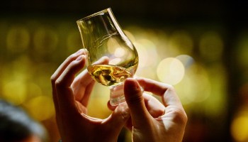 A person examines a whisky sample