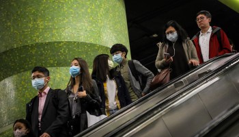 Commuters in a Hong Kong subway station wear face masks to protect against the spread of the coronavirus ahead of the Chinese New Year on Jan. 23.