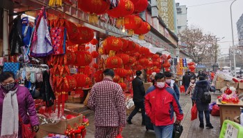 Shoppers wearing masks Wednesday prepare for Lunar New Year in Wuhan, ground zero of the coronavirus outbreak.