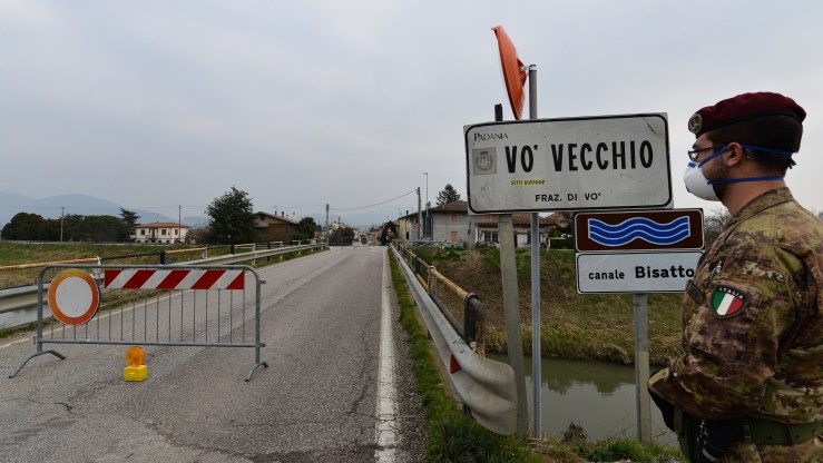 An Italian soldier patrols by a check-point at the entrance of the small town of Vo Vecchio, situated in the red zone of the COVID-19 the novel coronavirus outbreak, northern Italy, on February 24, 2020.