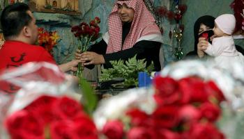 A Saudi man buys red roses for his wife at a flower shop in Riyadh.