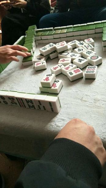 Rebecca Huang plays mahjong with her family to pass the time while unable to resume her business and too worried about the virus to spend time outside. (Courtesy Rebecca Huang)