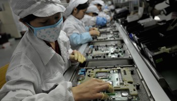 Workers assemble electronic components at the Foxconn factory in Shenzhen, China.