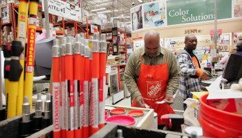 Home Depot employees work in the paint department