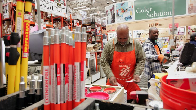 Home Depot employees work in the paint department