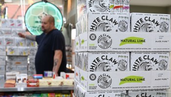 Cartons of hard seltzer White Claw are on display at the Round the Clock Deli in New York City in September.