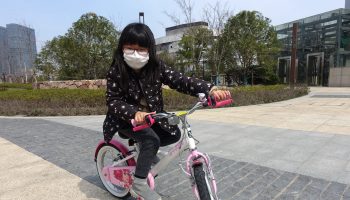 Ada Lu learned to ride a bicycle while staying in during the COVID-19 virus outbreak in Shanghai.