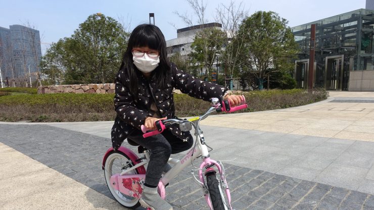 Ada Lu learned to ride a bicycle while staying in during the COVID-19 virus outbreak in Shanghai.