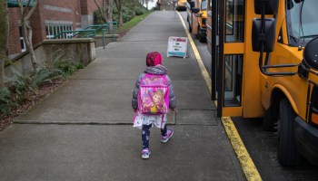 An elementary school student boards the bus in Seattle, Washington.