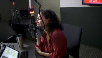 "This Is Uncomfortable" host Reema Khrais pictured here in a studio recording her show.