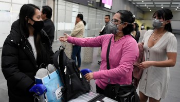 Passengers from a flight from South Korea wear protective face masks upon landing at Mexico City's international airport, on Feb. 28, 2020 as COVID-19 spreads worldwide.