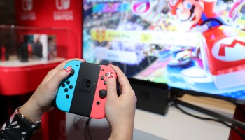 A person plays Mario Kart 8 on a Nintendo Switch console