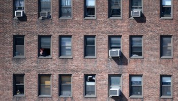 A person looks at of their window on March 24, 2020 in New York City