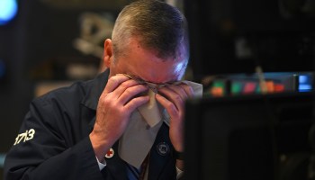 A trader wipes his face as he works during the closing bell at the New York Stock Exchange on March 3.