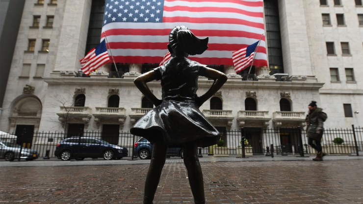 The Fearless Girl statue stands alone in front of an empty New York Stock Exchange on March 23, in New York City.