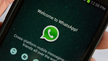 The WhatsApp app welcome screen on a phone.