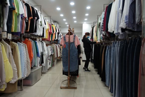 All clothes in this shop have been marked down in price between 10% to 30% in order for the company boss to recover some costs. (Charles Zhang/Marketplace)