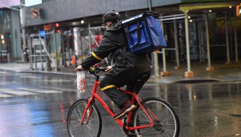 A food delivery person rides their bike in New York City on March 23.
