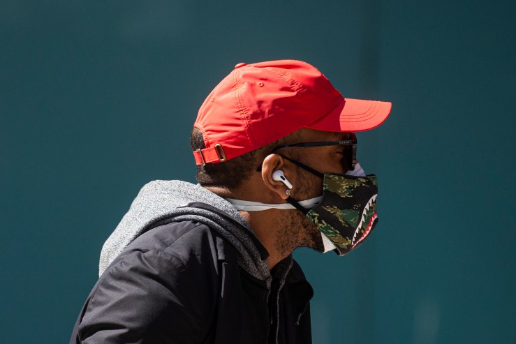 A man wears a printed cloth mask as he walks in Times Square on April 6, 2020 in New York City.