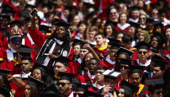 Graduating students in caps and gowns react as President Barack Obama delivers a commencement address at Rutgers University in New Brunswick, New Jersey, on May 15, 2016..