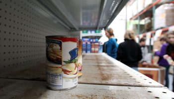 A shelf almost bare of canned food. With Americans stocking up on food for future needs, supplies of containers are running low.