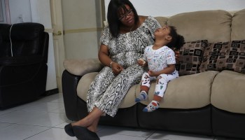 Jessie Morancy stays home with her nephew, Freddy Preseler, 2 years old, after being laid off from her job at the Fort Lauderdale–Hollywood International Airport. She has applied for unemployment benefits, joining the millions of Americans across the country who have done so.