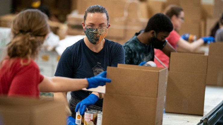 Volunteers pack boxes of food at the distribution center of the Capital Area Food Bank on April 9 in Washington, D.C.