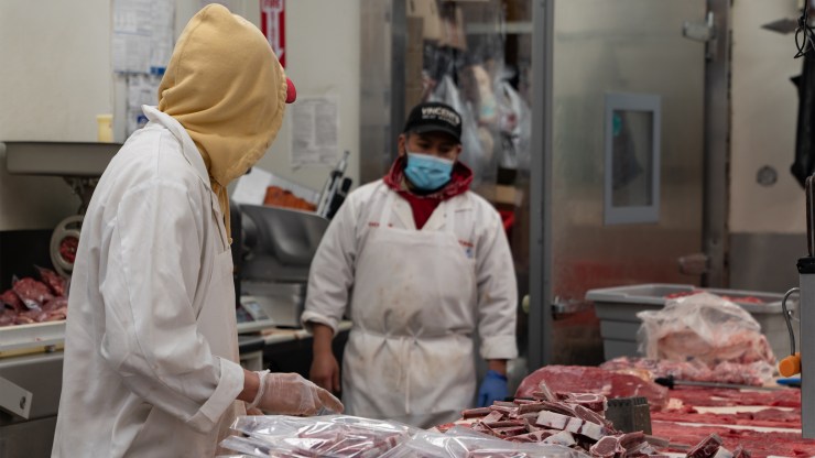A butcher processes meat at Vincent's Meat Market in the Bronx borough of New York City on April 17.