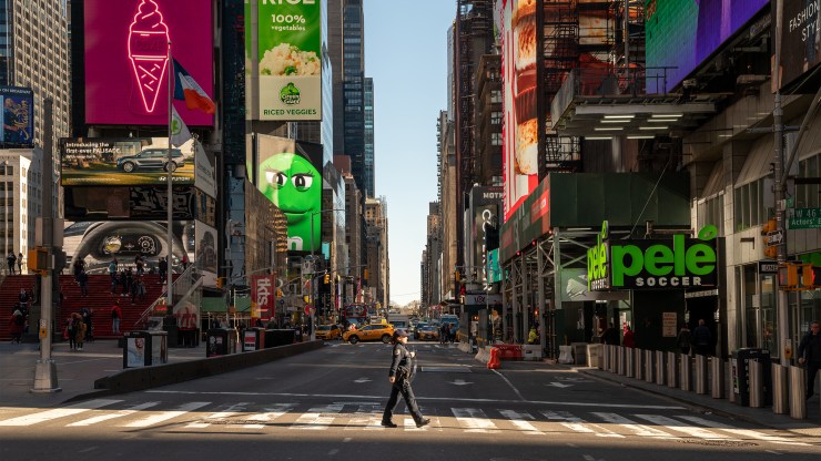 A police officer crosses the street in a nearly empty Times Square on March 12 in New York