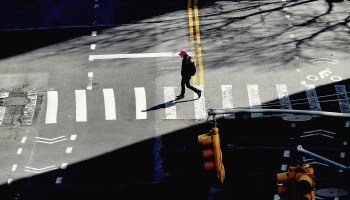 A person crosses the street on March 27 in New York City